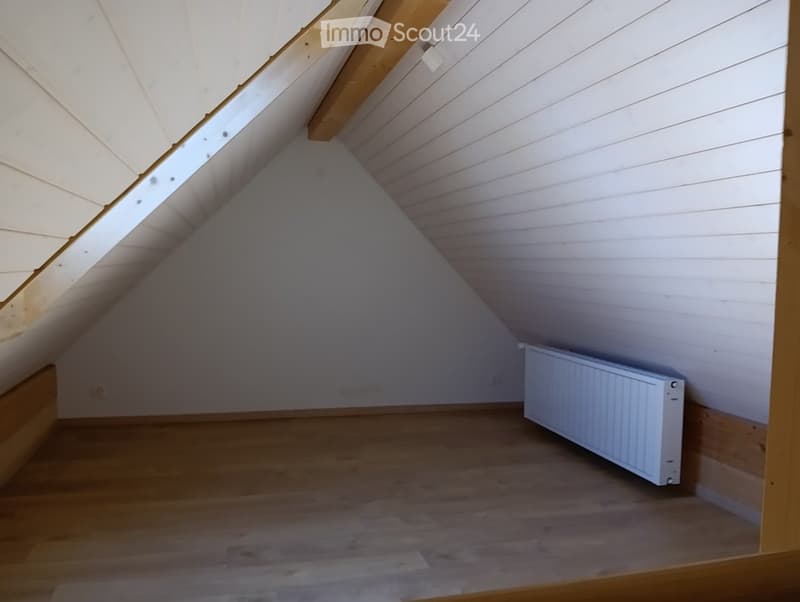 attic room, wooden beams, white walls, wooden floor, white radiator