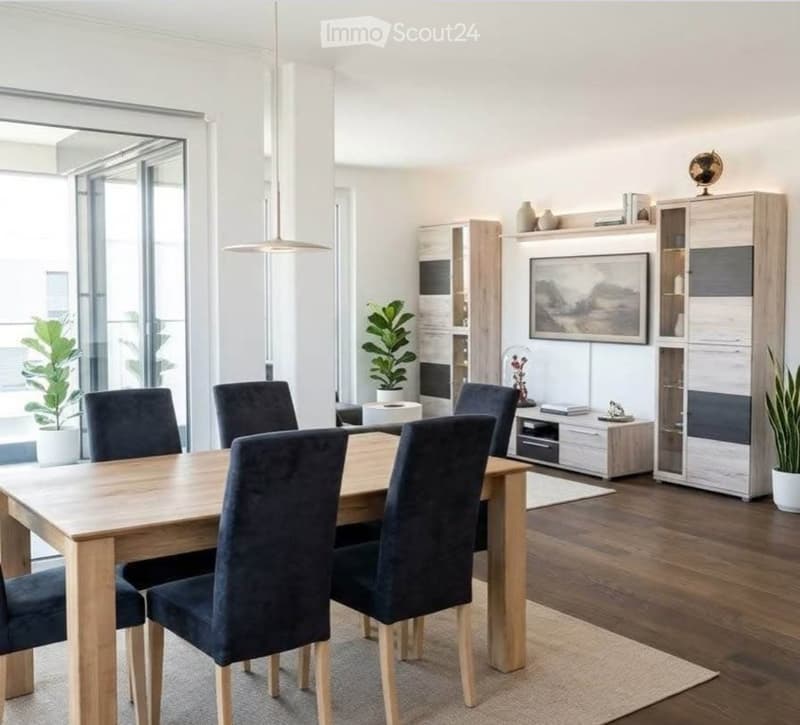 Modern dining room with a wooden dining table, four dark blue chairs, a hanging pendant light, a tall cabinet, and potted plants near the large windows offering a view.
