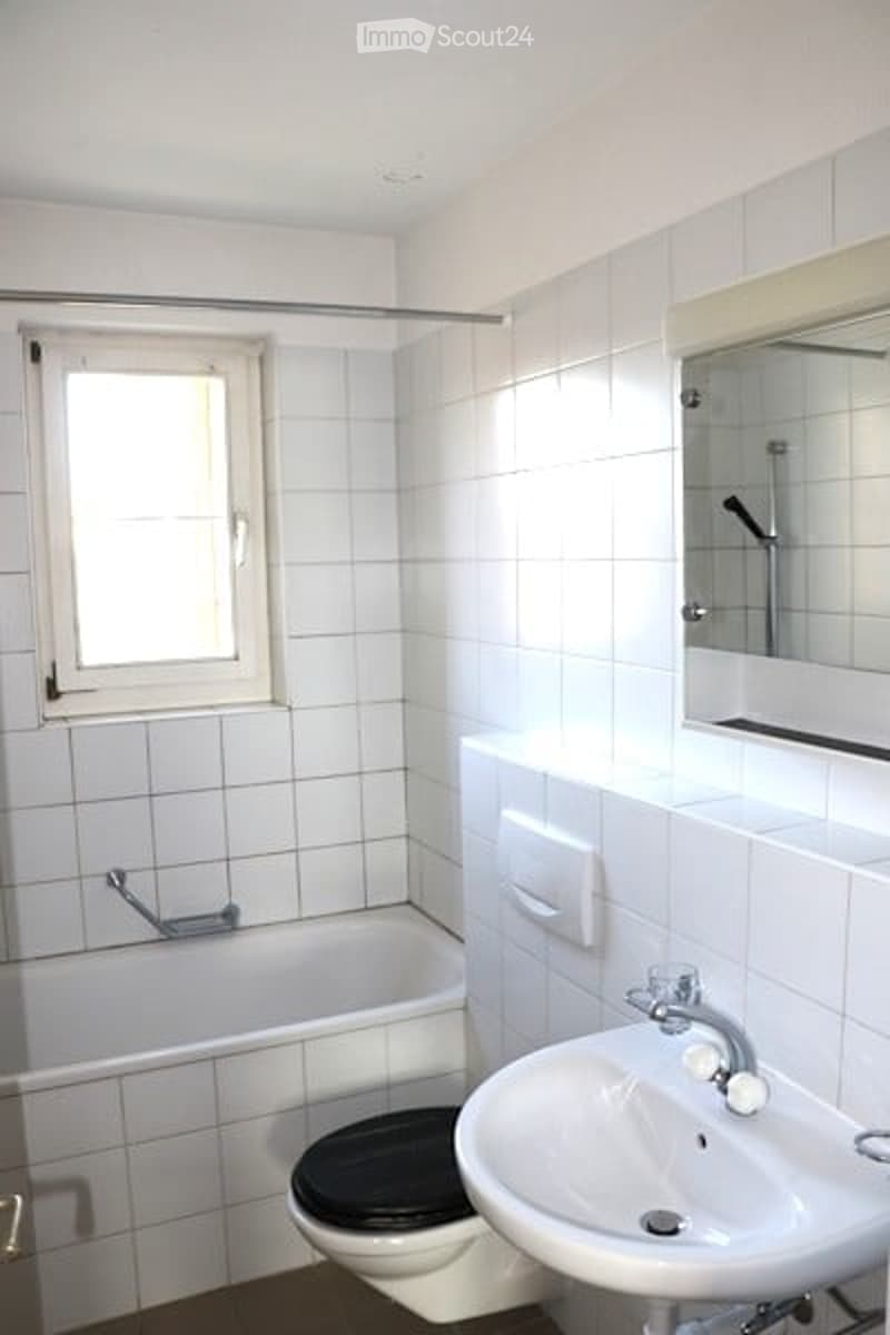 modern white bathroom, bathtub, toilet, sink, mirror, tiles, toilet paper holder