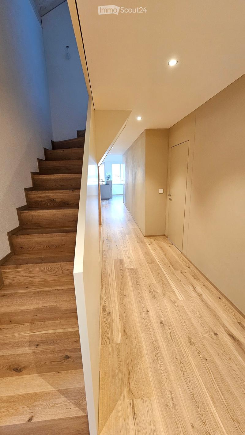 hardwood flooring, modern staircase, open layout, natural light, white painted walls