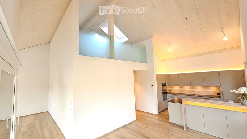 kitchen area, white cabinets, wood floor, island, lights