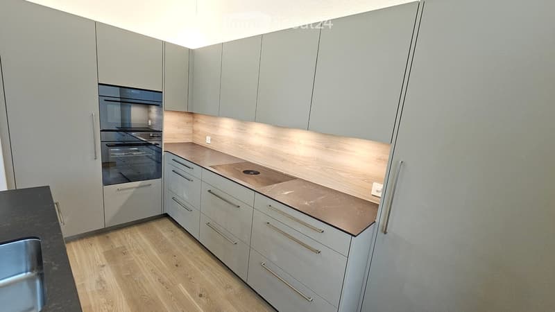 modern gray cabinets, wooden countertops, electric stove, stainless steel sink, integrated oven