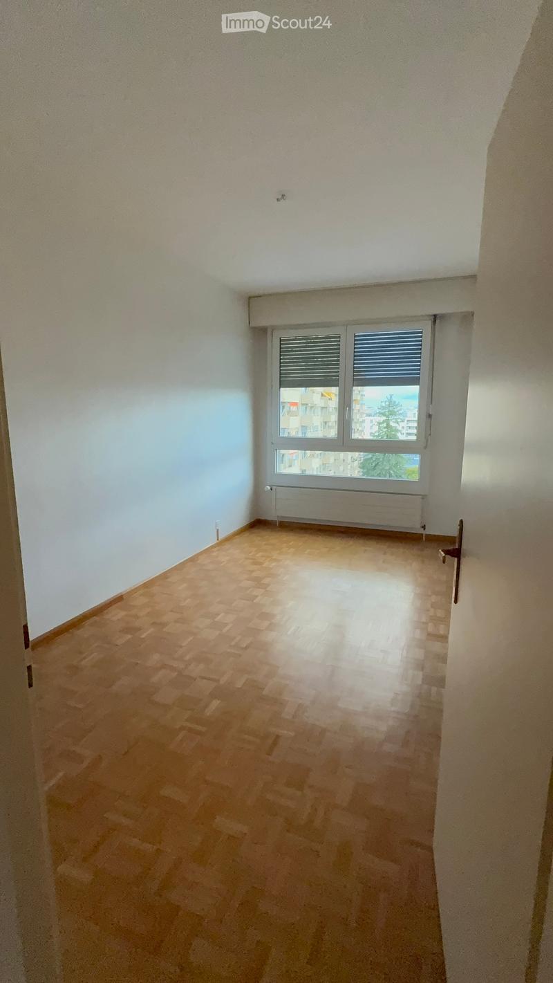 Empty room with wooden flooring, white walls, and a window with blinds. No furniture or equipment is present.