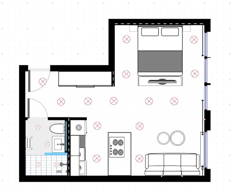Floor plan of a compact studio apartment featuring a living area with a sofa, a kitchenette with a sink and refrigerator, a sleeping area with a bed, and a small bathroom with a toilet and shower.