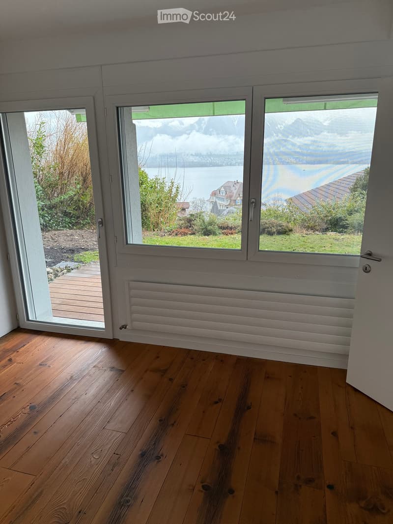 wooden floor, sliding glass doors with view, radiators, wooden deck outside