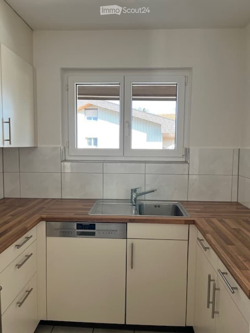 white cabinets, wooden countertops, stainless steel sink, integrated dishwasher, window