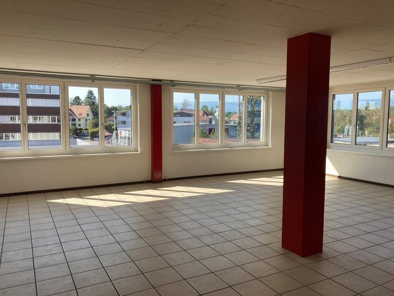 tiled floor, white walls, large windows, red column