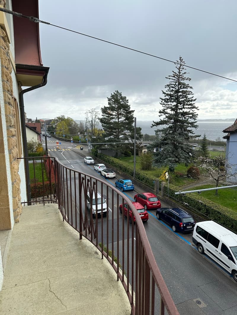 balcony with view over the street, cars, and landscape