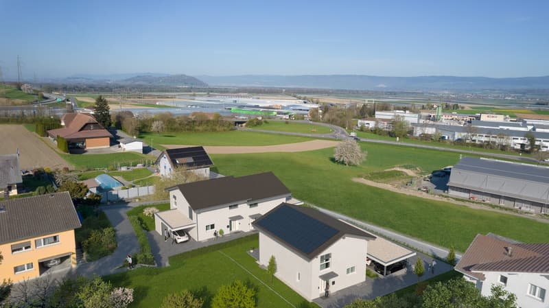 New construction, solar panels on roof, 3 houses, green garden, solar panels, parking