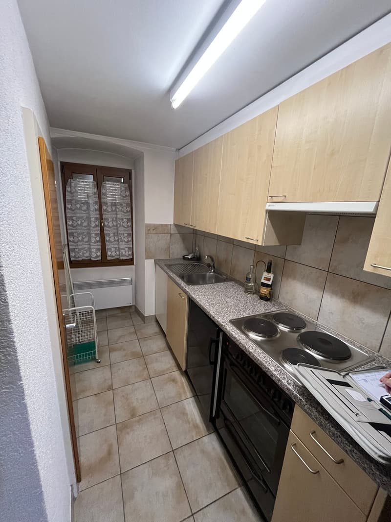 kitchen with sink, stove, oven, cabinets, tiled floor, window with curtains