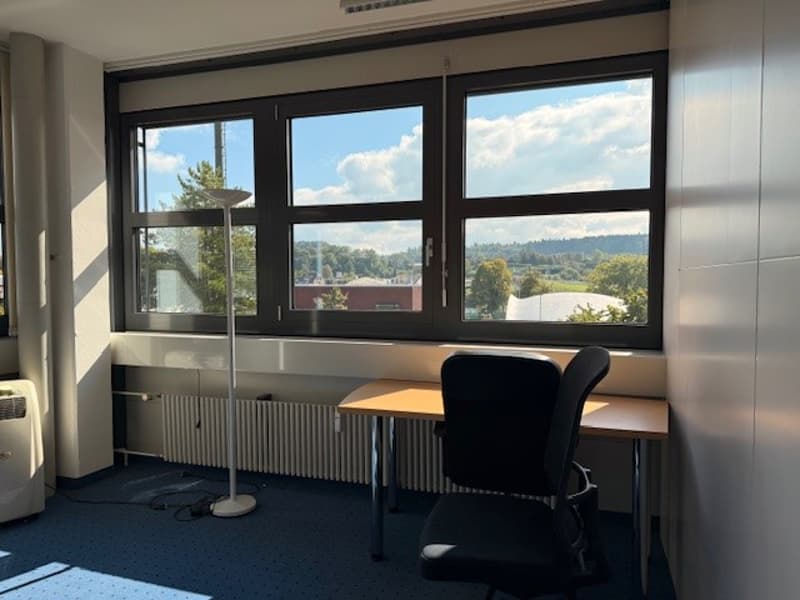 desk, chair, radiator, floor lamp, large windows