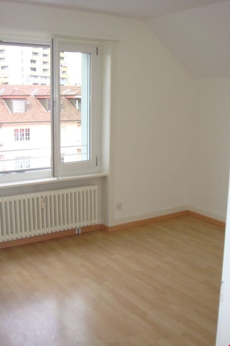 empty room, wooden floor, white walls, large window with balcony