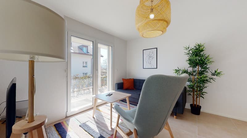 modern open-plan living area with balcony access, large glass doors, comfortable furniture, decorative elements