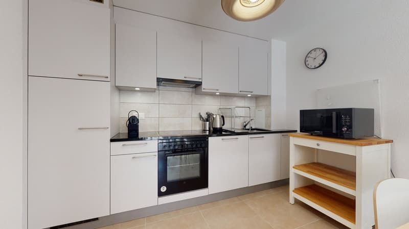 white kitchen with oven, microwave, sink, cabinets, and drawers