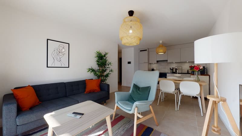 living room with white walls, dark blue couch, wooden coffee table, 4 chairs, floor lamp, dining table