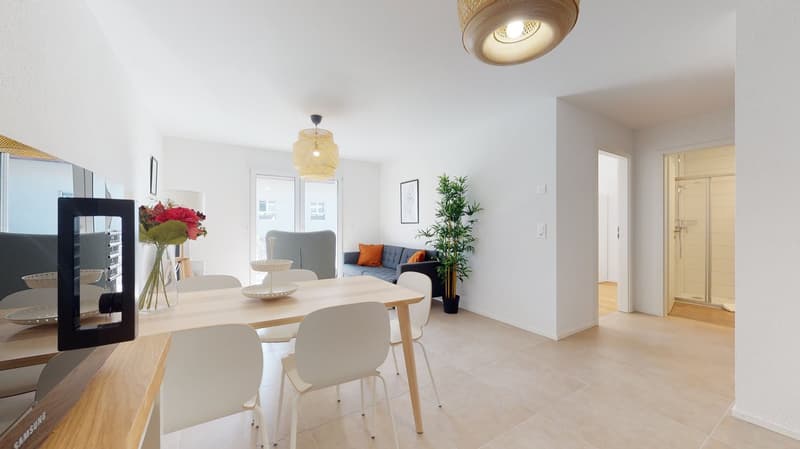 Dining room with wooden table and chairs, flowers, picture frame, lamps, couch, and potted plant