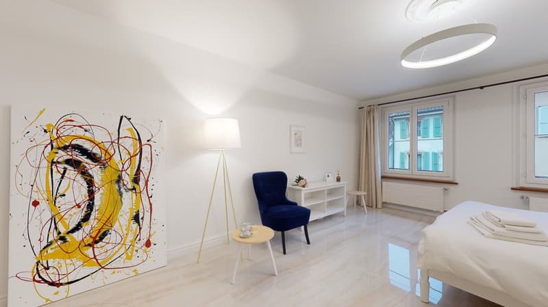 white walls, bed, chair, side table, painting, lamps, windows
