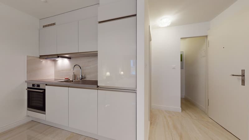 modern kitchen with integrated oven, dishwasher, granite countertop, stainless steel sink, faucet, light marble floor