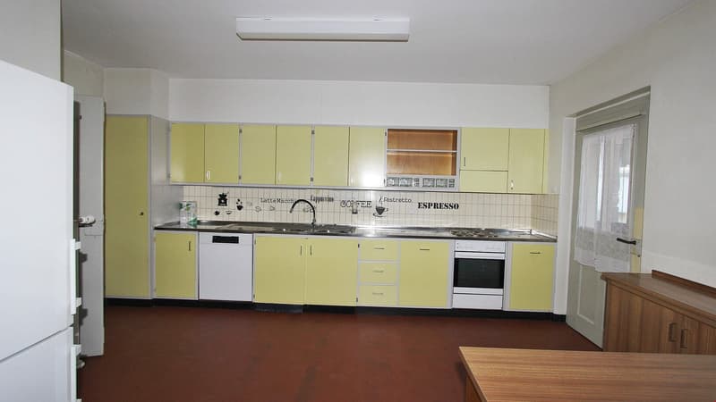 yellow cabinets, white appliances, tiled backsplash, red floor, white refrigerator