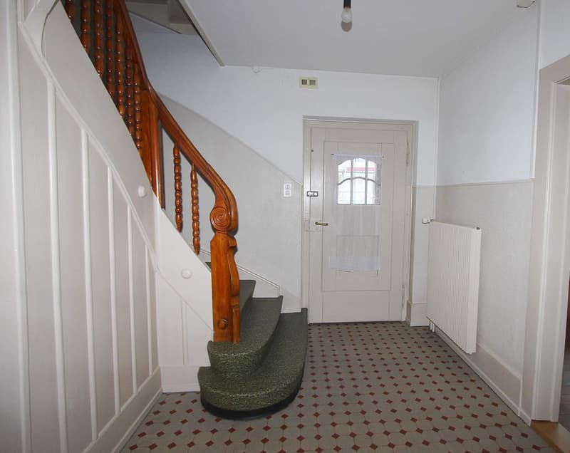 wooden staircase, white walls, tiled floor, white door, radiator