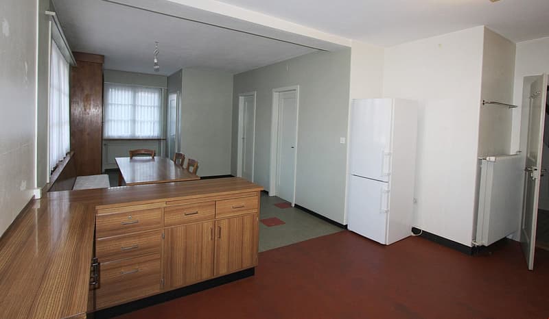 kitchen with wooden cabinets, white refrigerator, dining table with chairs, window with white curtains