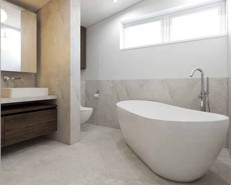 Spacious bathroom with a freestanding bathtub, vanity with a sink, and large windows providing natural light. The walls and floor are covered in light-colored tiles, creating a modern and minimalist aesthetic.