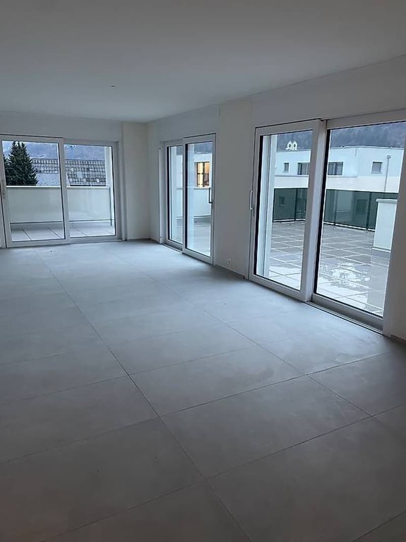 empty room, tiled floor, glass sliding doors, balcony access, white walls, minimalistic design