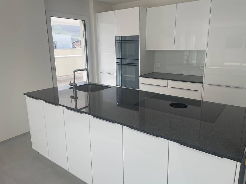 Modern kitchen, granite countertops, white cabinets, stainless steel sink, gas stove, oven, sliding glass door