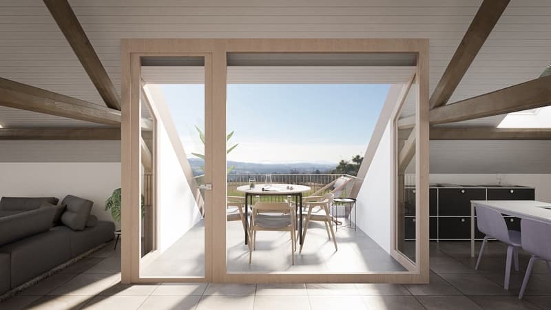 Open-plan living and dining area with a couch, chairs, and a table. Large windows and a balcony with a view of the mountains.