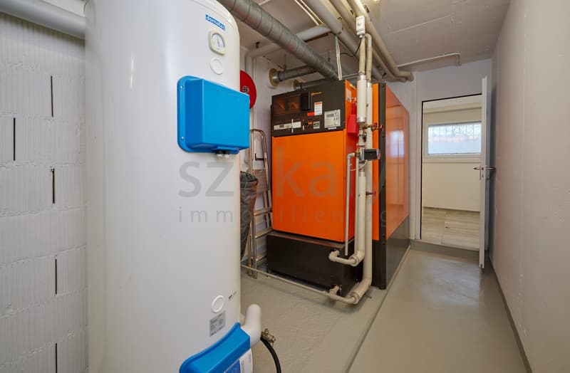 Gas heater, white pipes, ladder, door, concrete floor