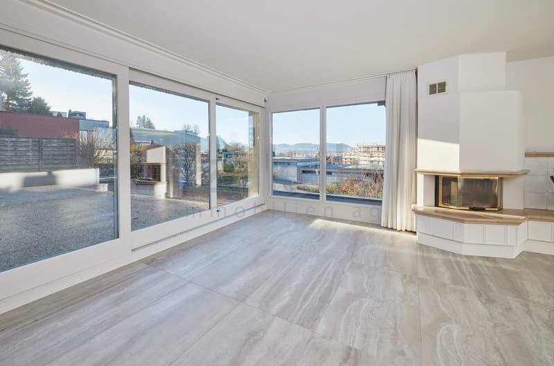 marble flooring, fireplace, large sliding glass doors leading to terrace, large windows