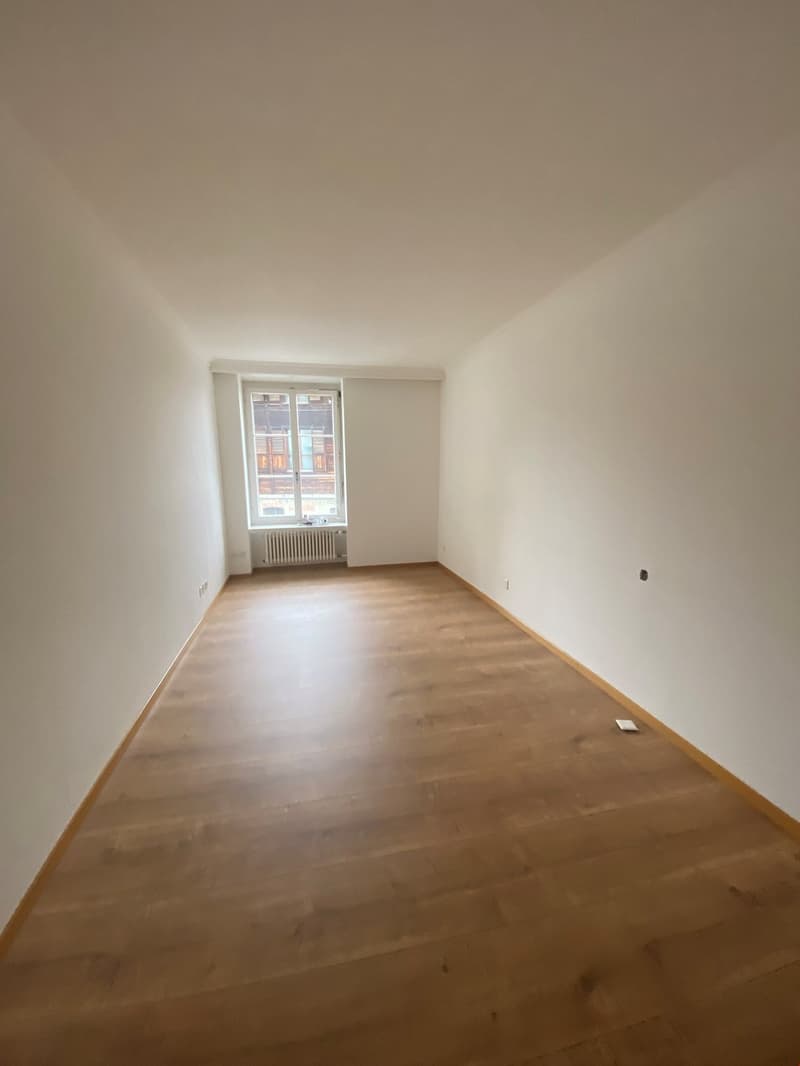 empty room, hardwood floor, white walls, window, radiator