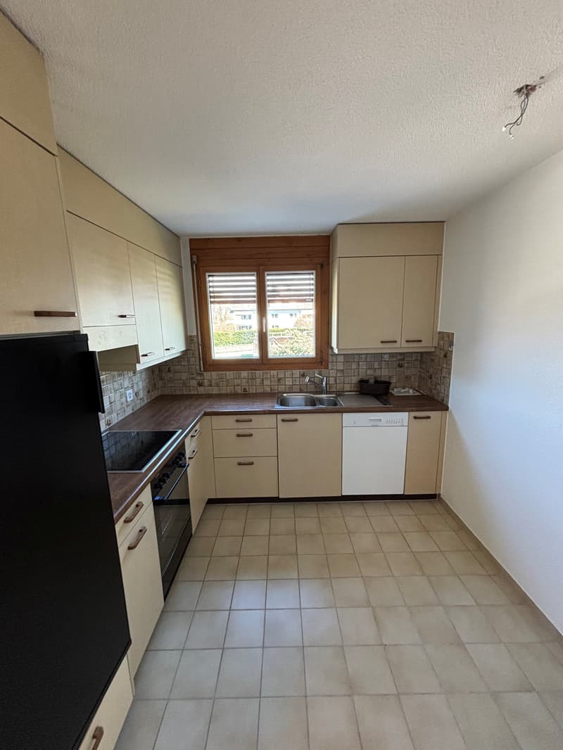 white tiled floor, wooden countertops, black refrigerator, gas stove, sink, dishwasher, wooden cabinets