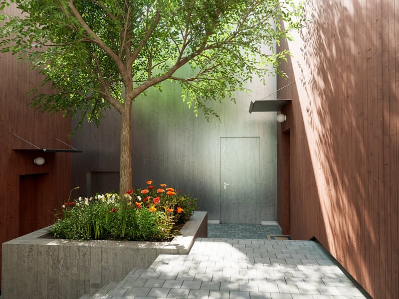 wooden walls, brick flooring, central tree, flower bed, open doorway
