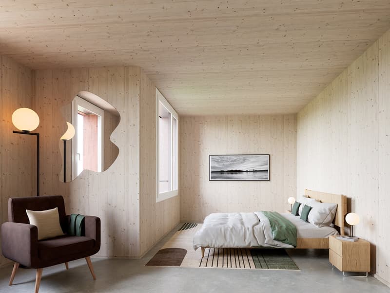 bedroom with bed, chair, lamps, rug, picture frame, wooden walls