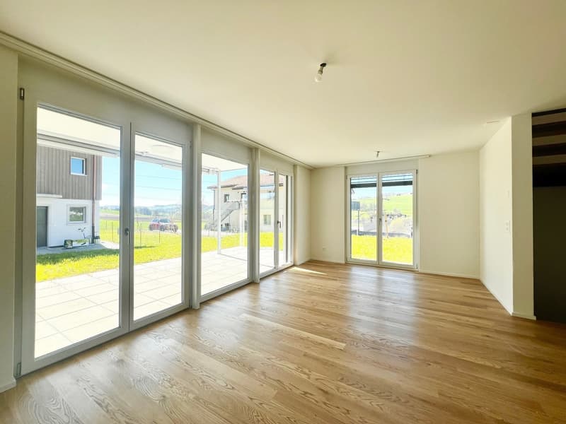 large windows, sliding glass doors, wooden floor, open space, view of the outside