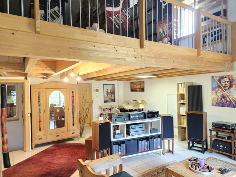 wooden floor, wooden balcony, wooden cabinet, red carpet, wooden chair, wooden table, speakers, shelves, paintings, musical instruments