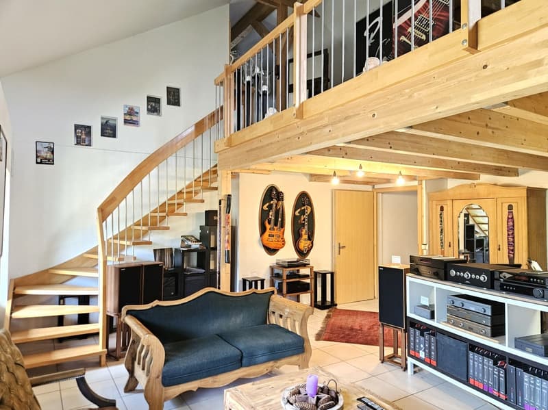wooden couch, wooden coffee table, wooden staircase, wooden floor, wooden ceiling, speakers, rug, wooden cabinet, guitar posters