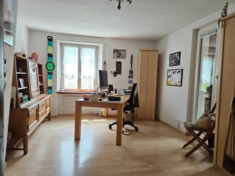 wooden desk, office chair, computer, monitor, books, wooden cabinet, picture frames, wooden chair, wooden floor