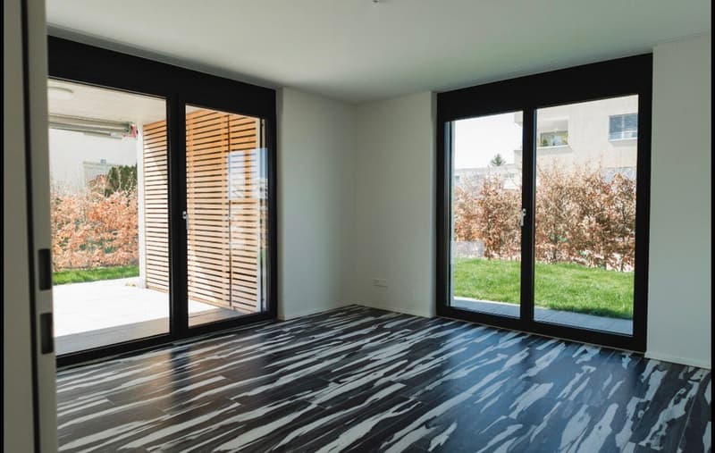 empty room, sliding glass doors, wooden slats, black and white flooring, outdoor view