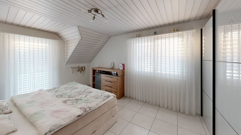 Bedroom: bed, pillow, blanket, dresser, window with curtains