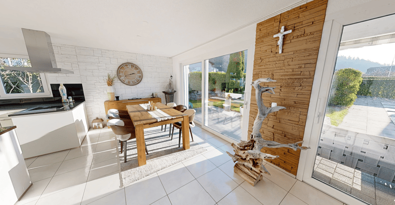 white tiled floor, white walls, wooden dining table, dining chairs, kitchen area, sliding glass door to terrace, decorative pieces