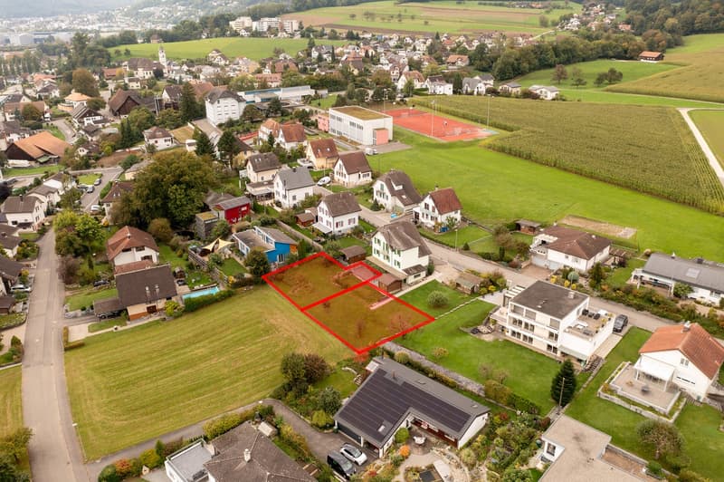 Plot of land, surrounded by other residential properties, tennis court, and greenery.