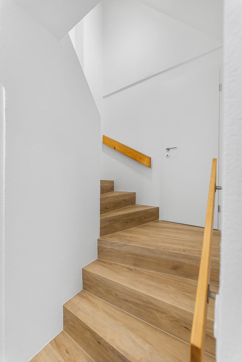 wooden steps, white walls, wooden handrail