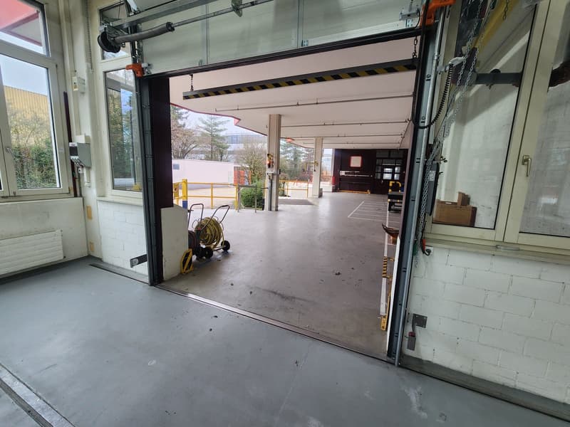 empty garage, automatic door, empty, no visible equipment or vehicles