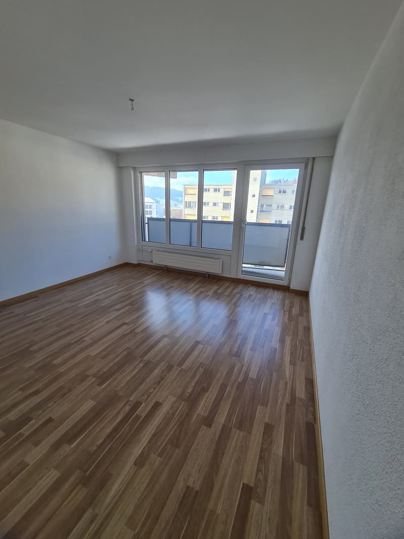 empty room, wooden floor, white walls, large windows, balcony
