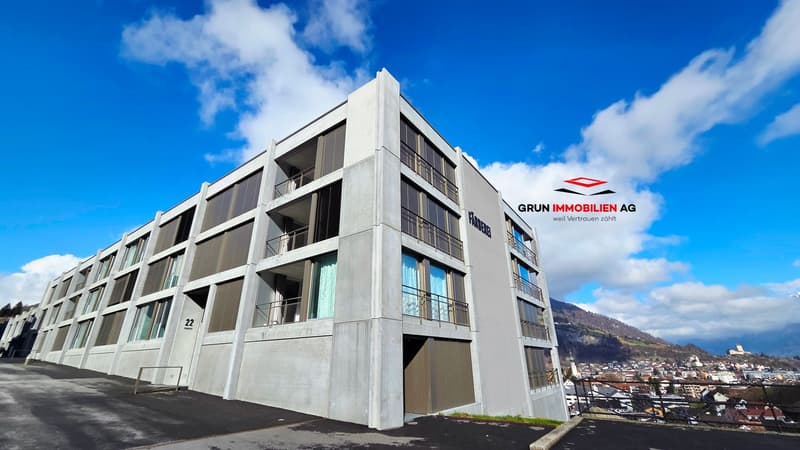 Modern apartment building, concrete exterior, multiple floors, balconies, windows, entrance