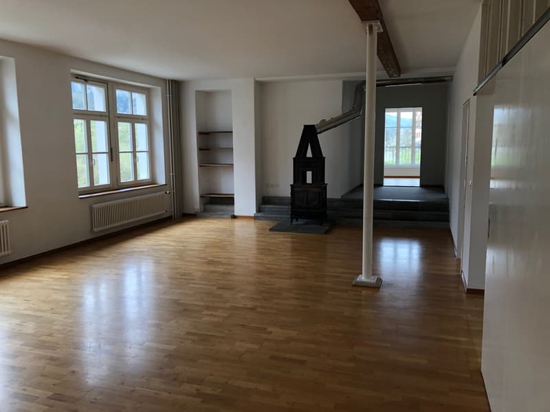 empty room, wooden floor, white walls, radiator, fireplace, windows, stairs