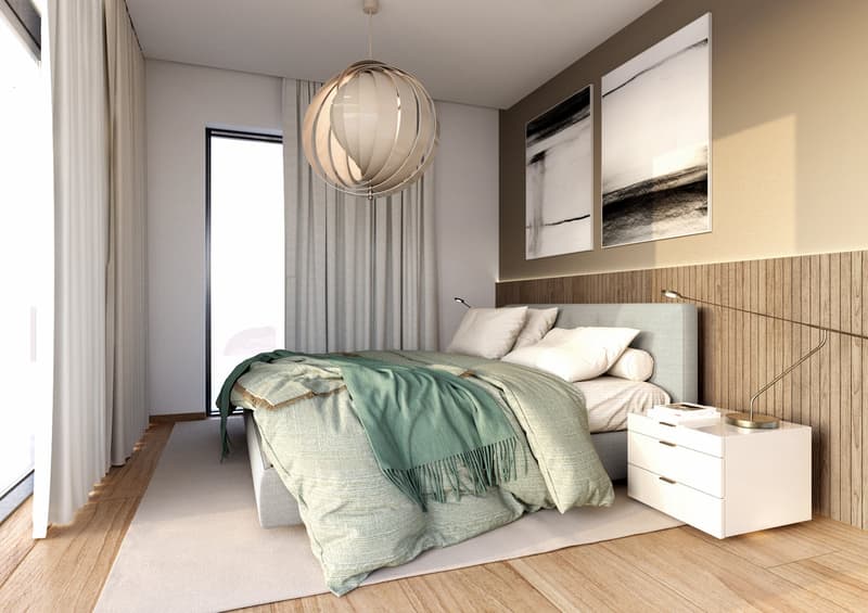 A bedroom with wooden floors, white walls, a large bed with pillows, a nightstand with drawers, a pendant lamp, a curtained window, and an abstract painting on the wall.