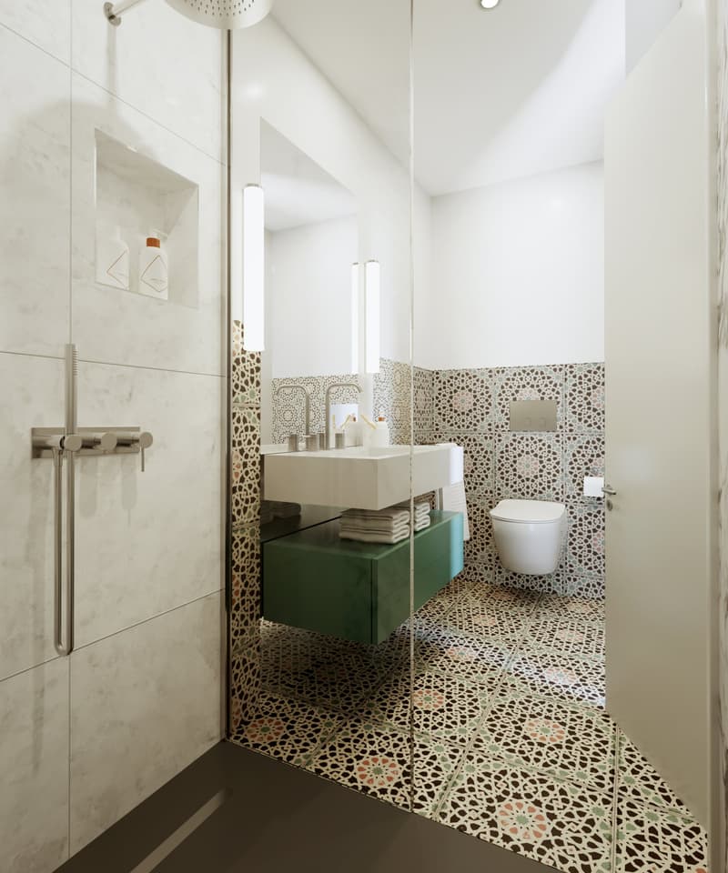 Marble walls, dual sinks, green cabinet, toilet, modern style, patterned tiles, toilet paper holder, and two wall lights.